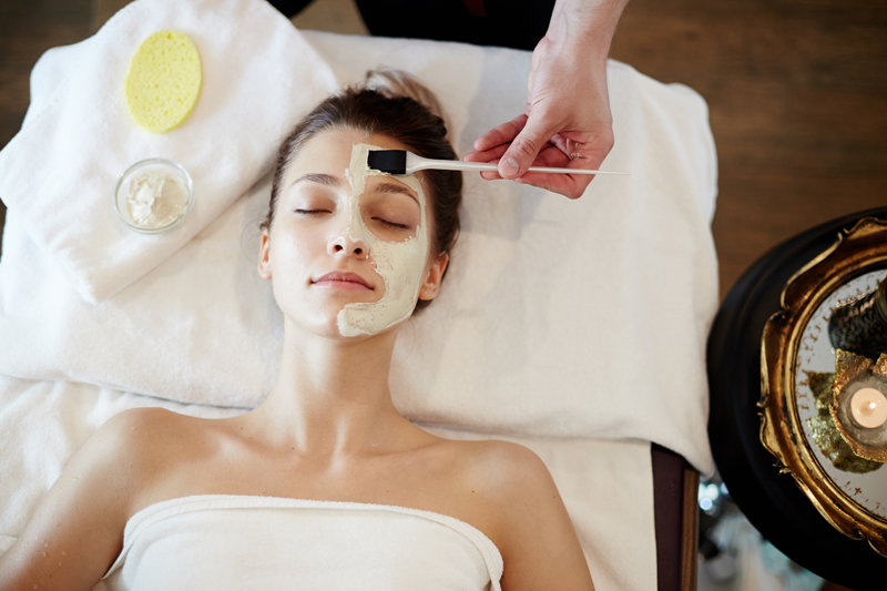 A photo of a woman getting skincare in a spa